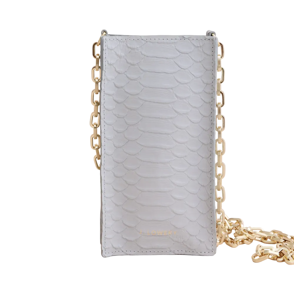 Light blue phone case with gold chain on a beige background