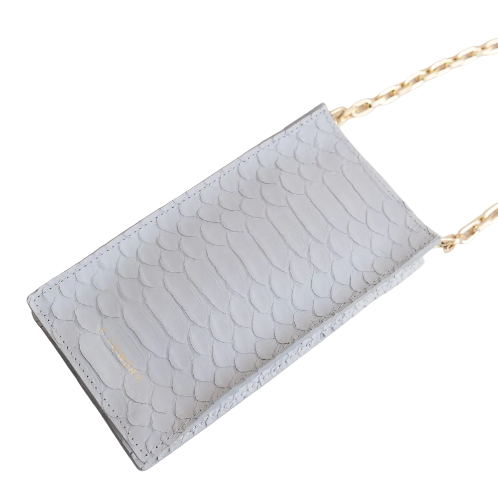 Light blue textured wallet with a gold chain on a beige background