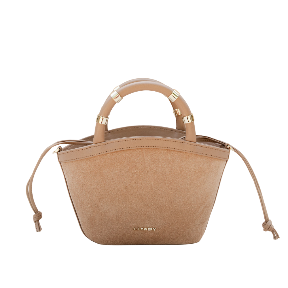 Beige handbag with gold accents on a beige background