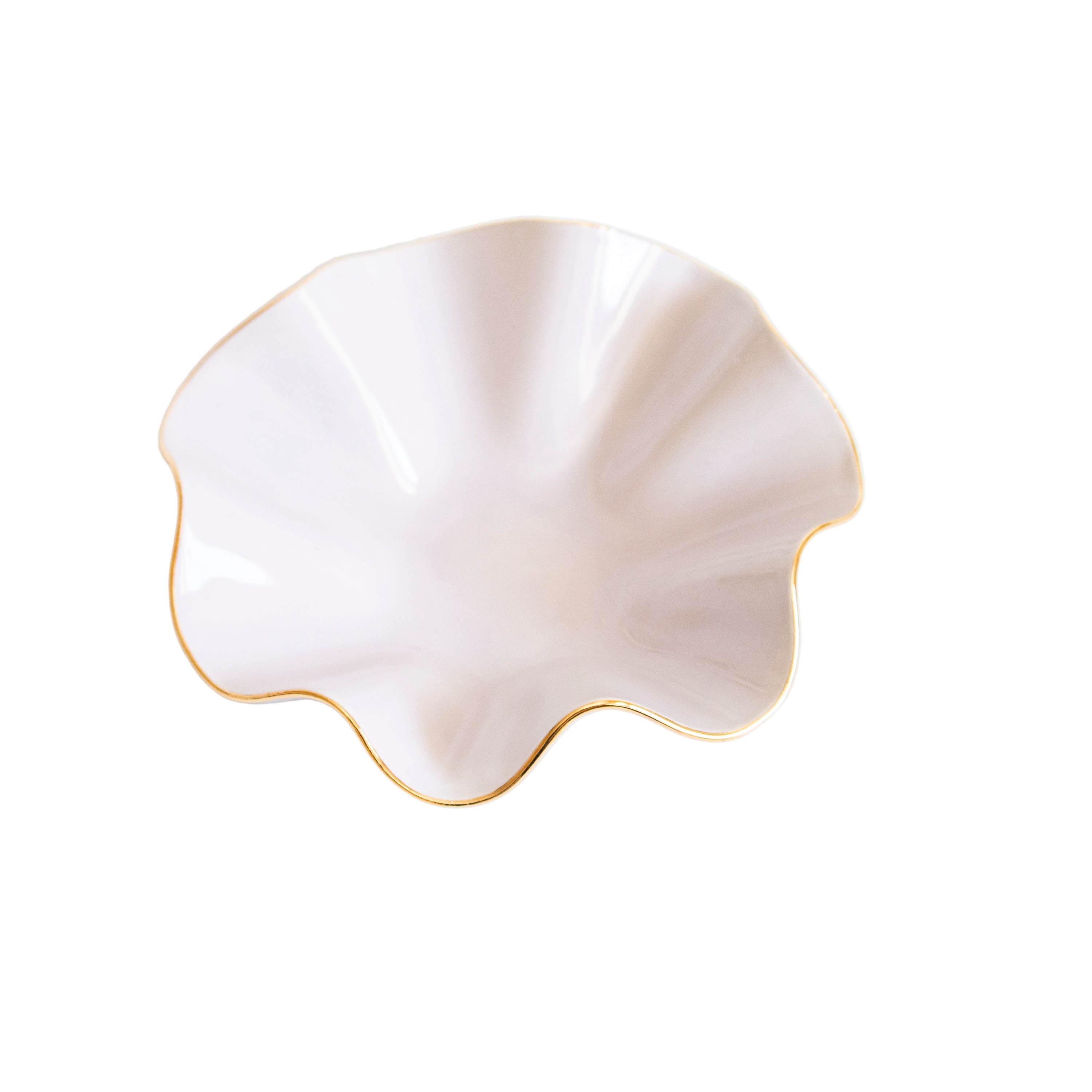 Shell-shaped ceramic dish with gold rim on a white background