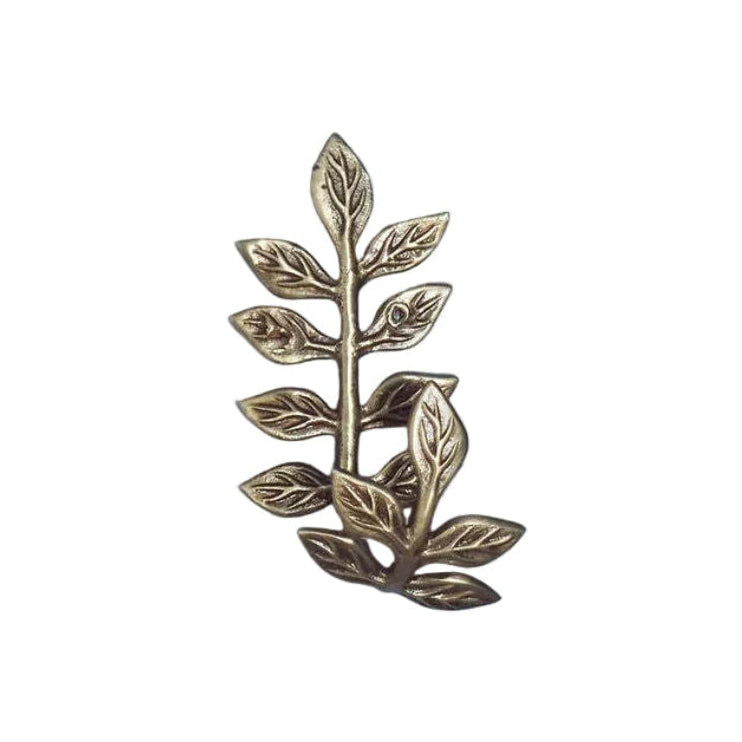 Bronze leaf-shaped brooch on a white background