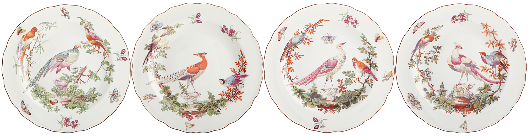 Set of four decorative plates with bird and floral designs on a white background