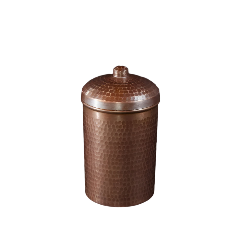 Copper jar with a textured surface on a black background