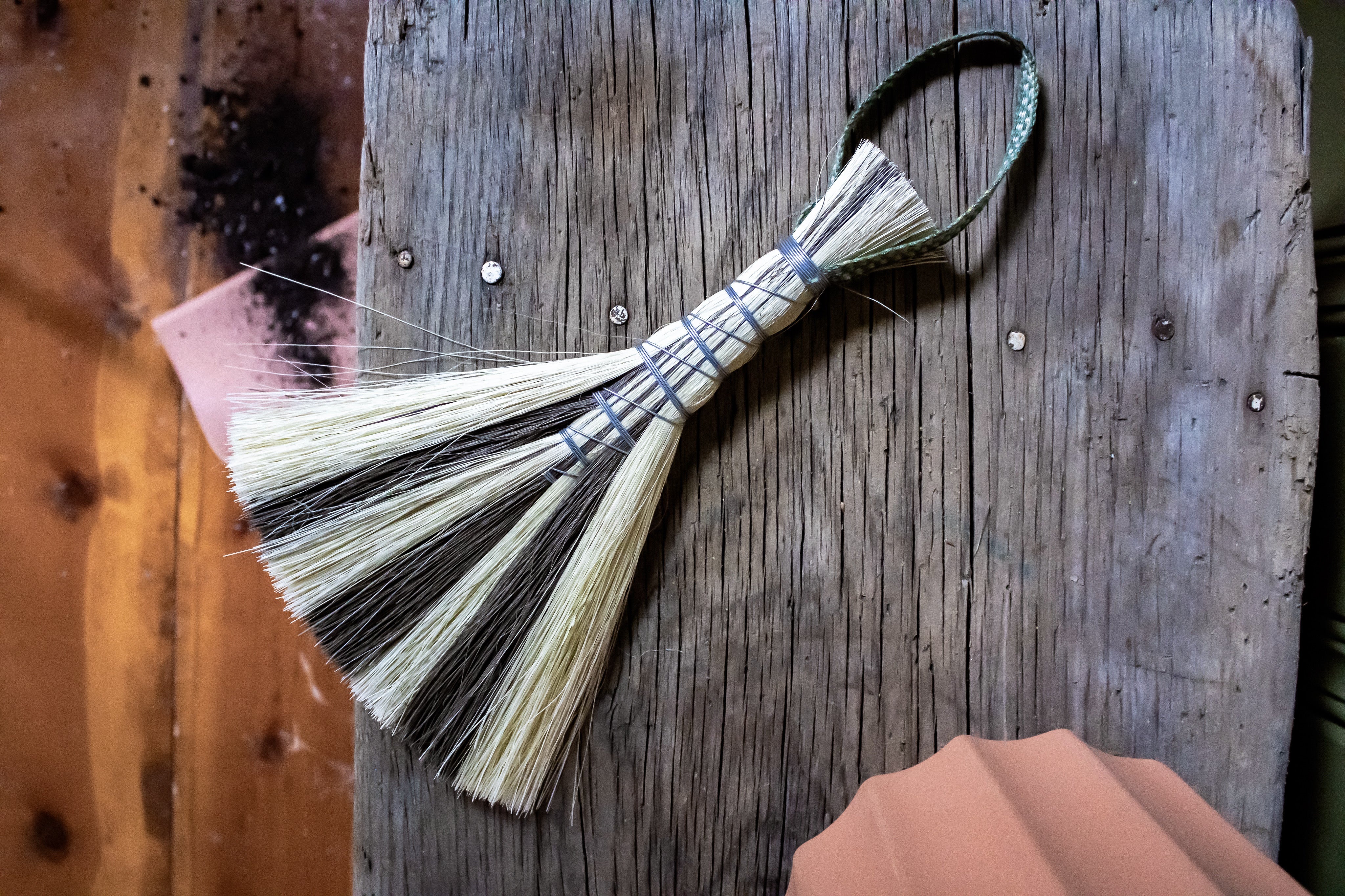 Metal wrapped brushes and brooms