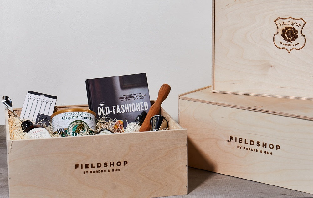 Wooden Fieldshop-branded gift box containing pantry and bar goods.