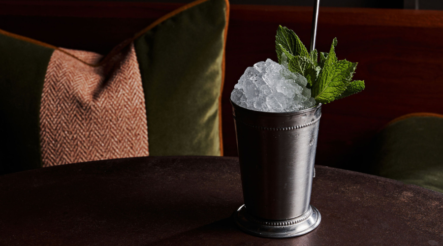 Mint julep on a black marble table.