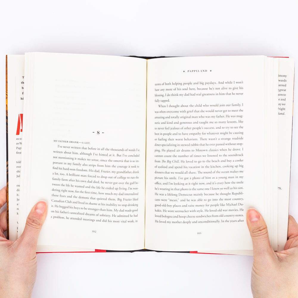 Open book held by hands with a white background