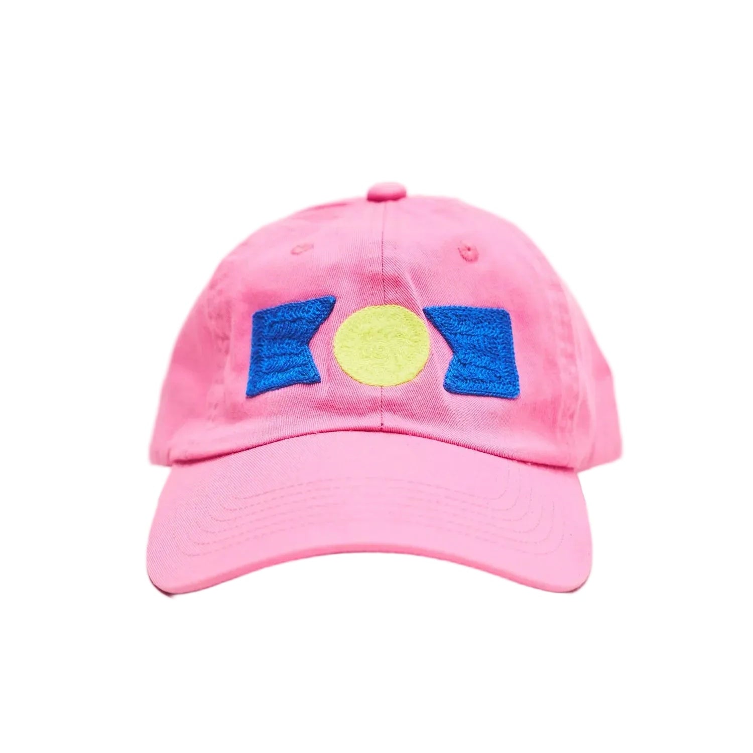 Pink baseball cap with blue and yellow design on a light gray background