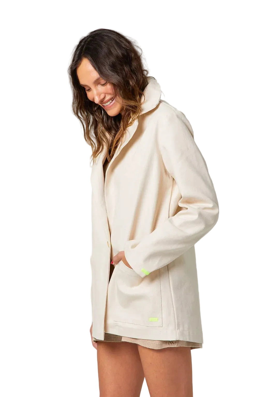 Woman wearing a beige coat on a plain background
