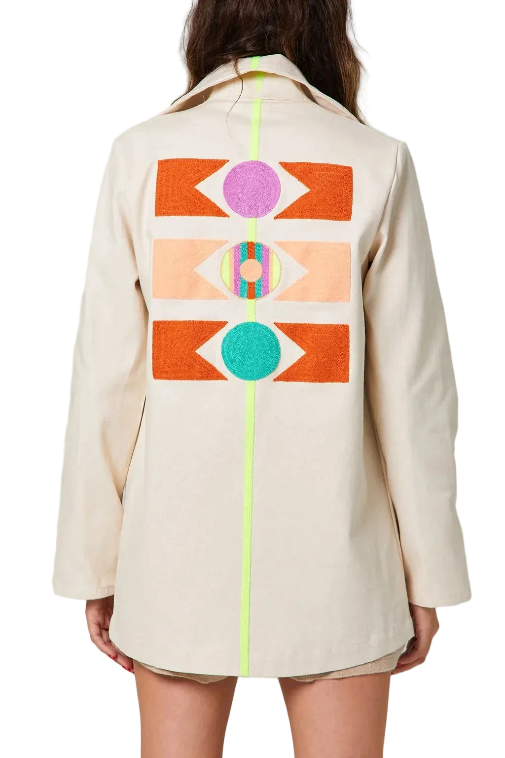 Beige coat with colorful geometric patterns on the back against a gray background