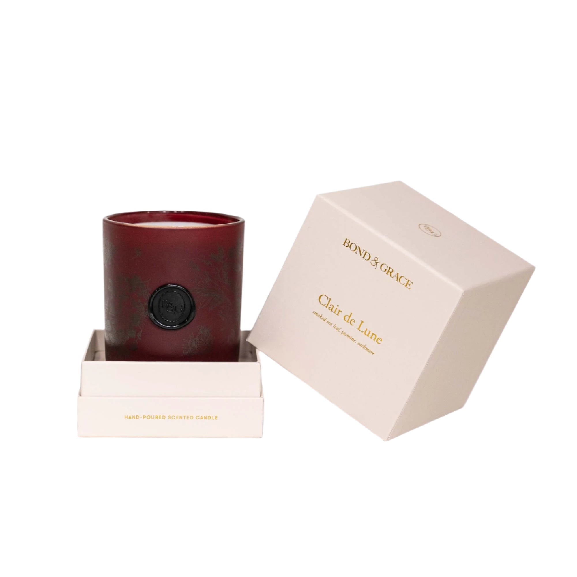 Red candle in a decorative box with 'Bond & Grace' branding on a white background