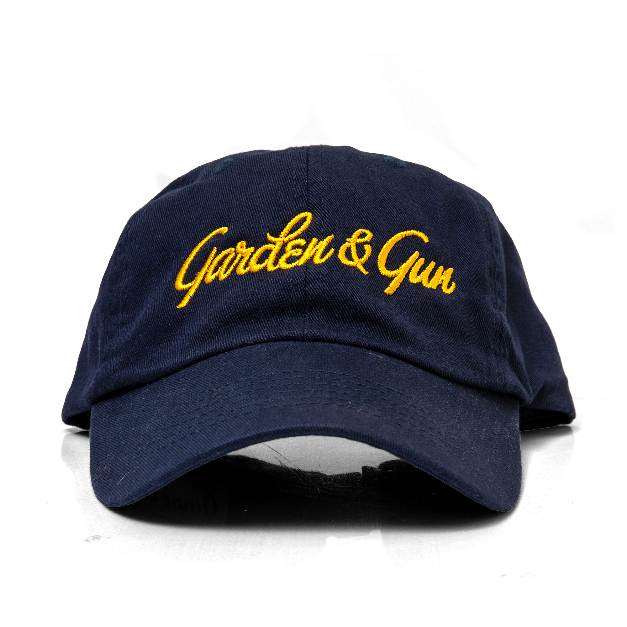 Navy blue cap with yellow 'Garden & Gun' text on a white background