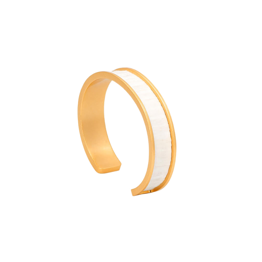 Gold and white bangle on a light gray background