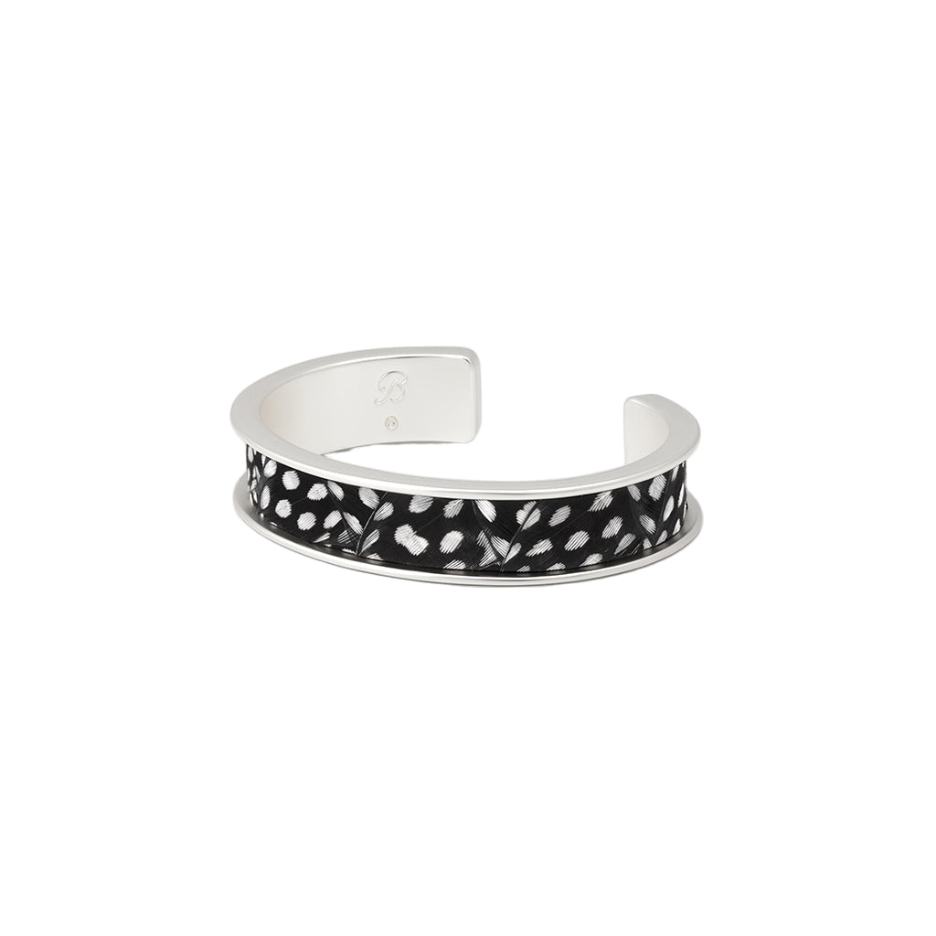 Silver bracelet with black and white pattern on a white background