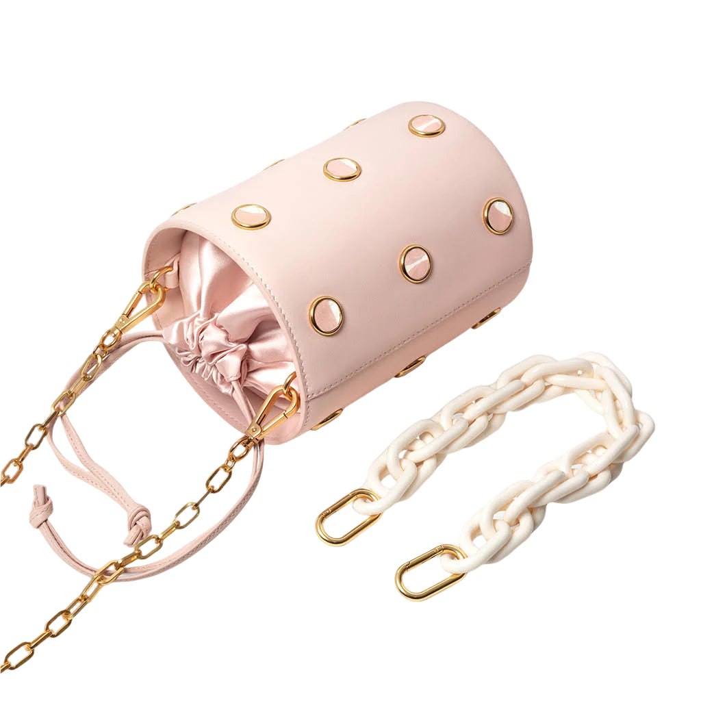 Pink handbag with gold chain strap on a white background