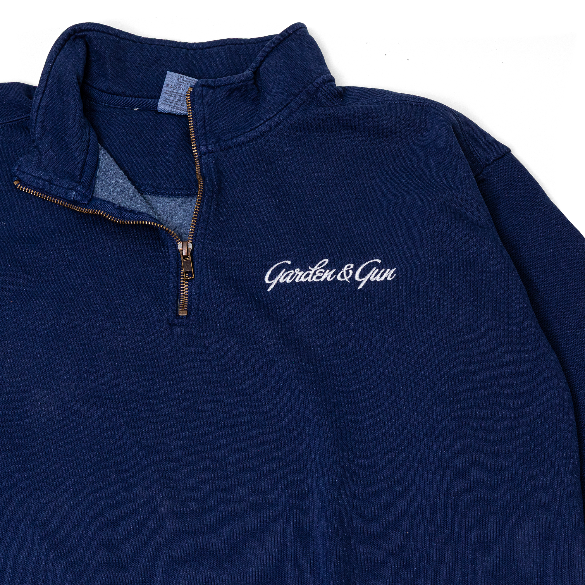 Navy blue pullover with 'Garden & Gun' logo on a white background