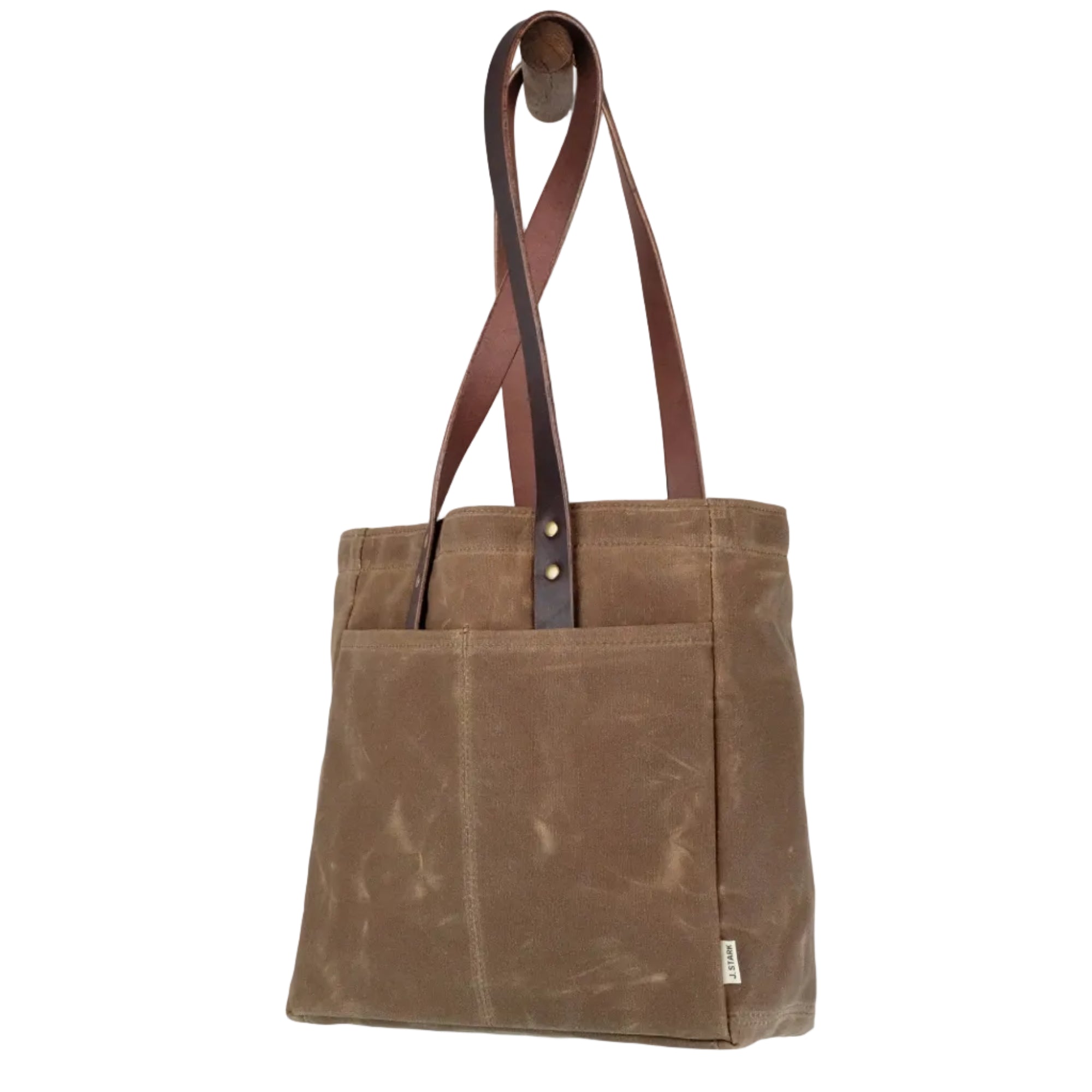 Brown tote bag with leather straps on a light gray background