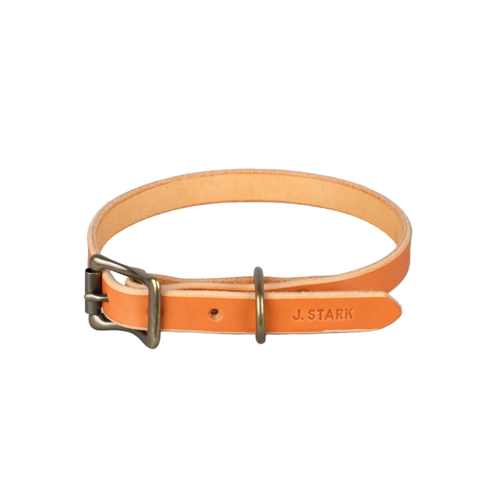 Orange leather dog collar with brass buckle on a gray background