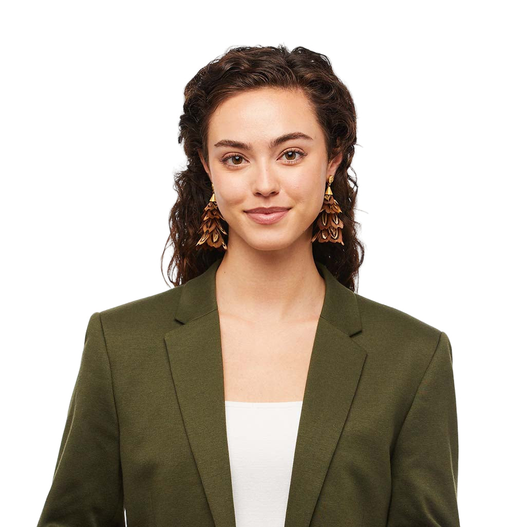 Woman wearing an olive green blazer over a white top on a white background