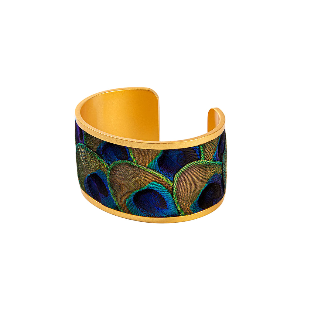 Cuff bracelet with peacock feather pattern on a white background