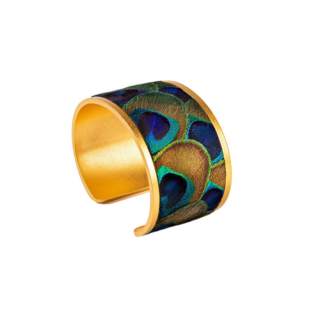 Gold bracelet with peacock feather pattern on a white background