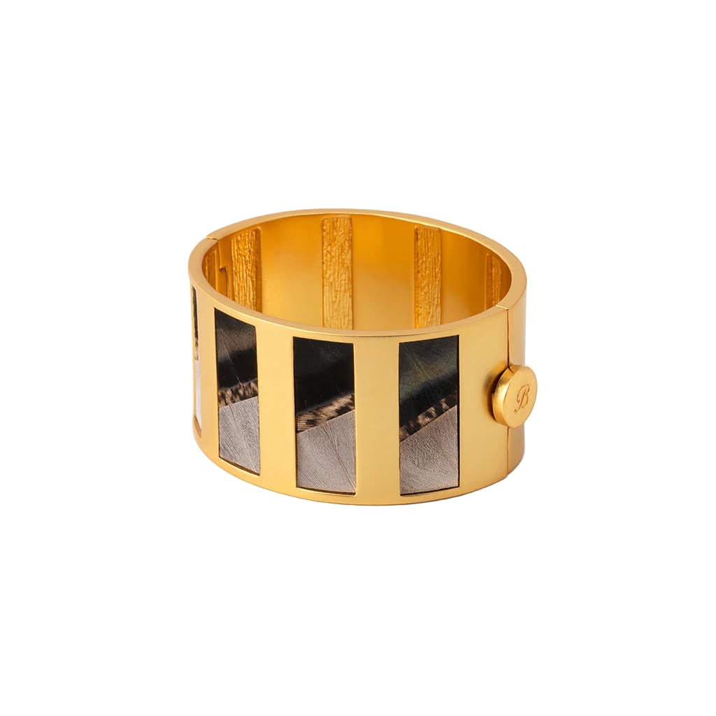 Gold bracelet with a textured design on a white background