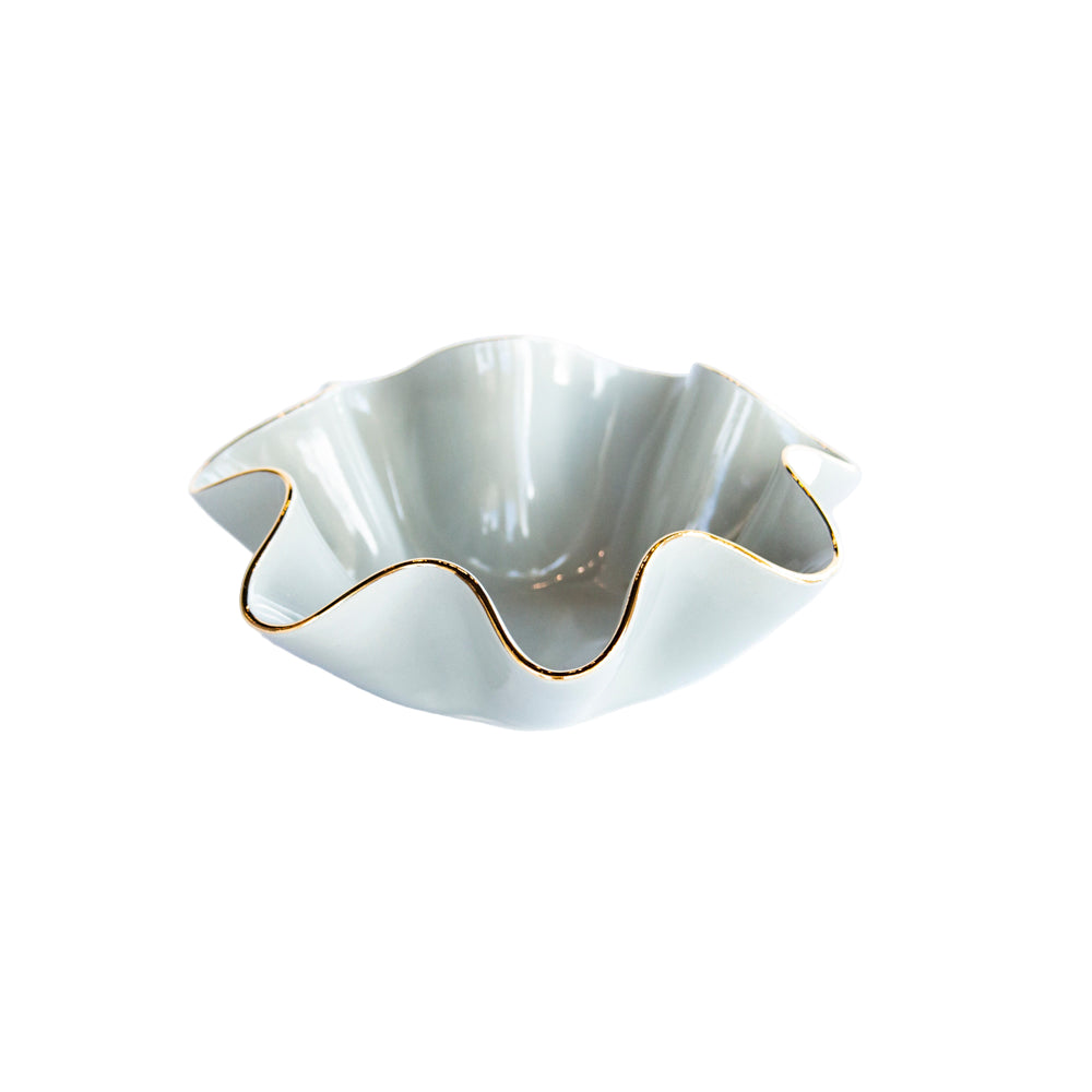 White ceramic bowl with gold rim on a white background