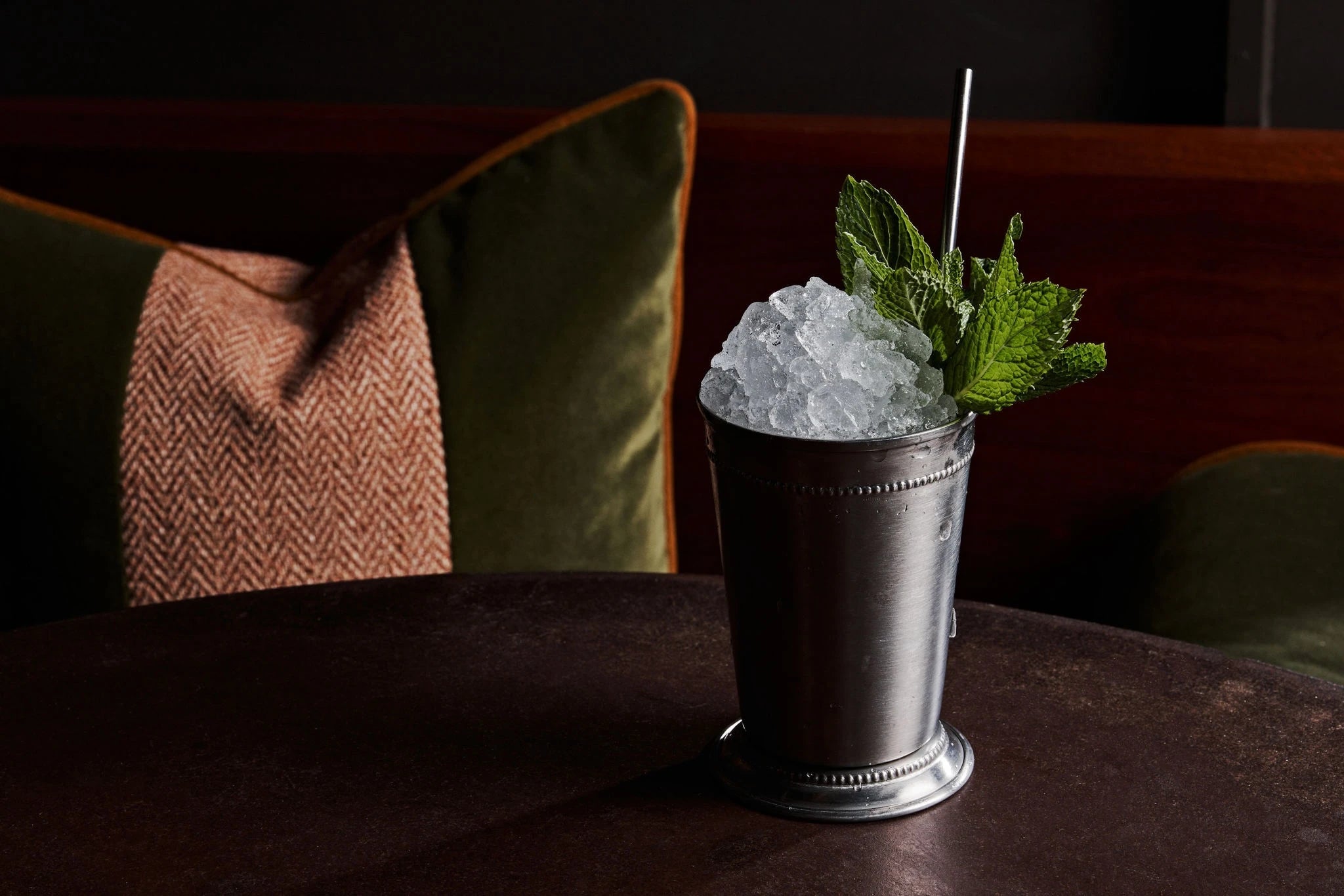 Mint julep on a black marble table.