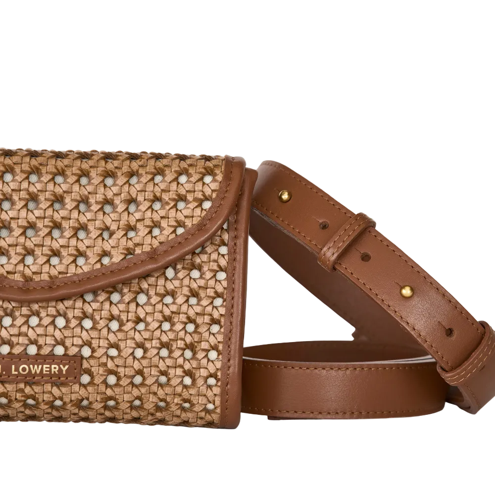 Brown woven handbag with a strap on a light gray background