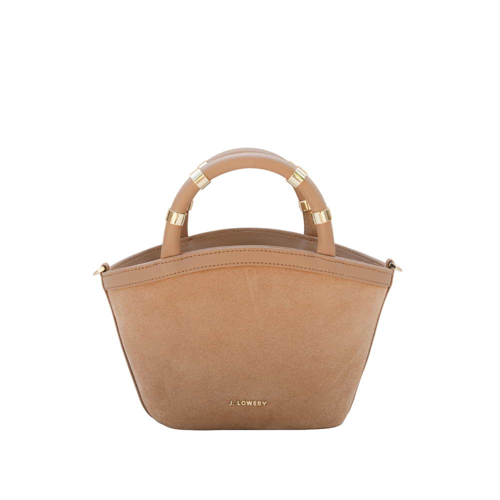 Beige handbag with gold accents on a beige background