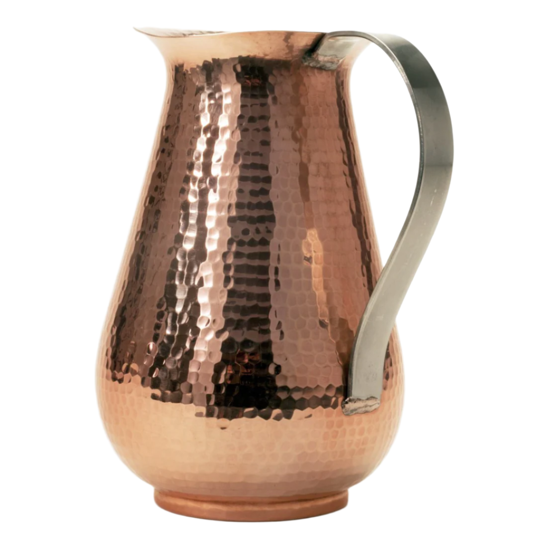 Copper pitcher with a silver handle on a white background