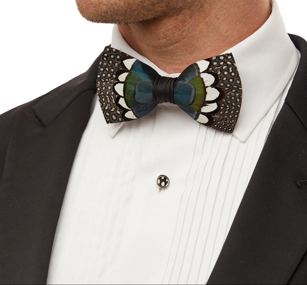 Man wearing a decorative bow tie with a black suit and white shirt.