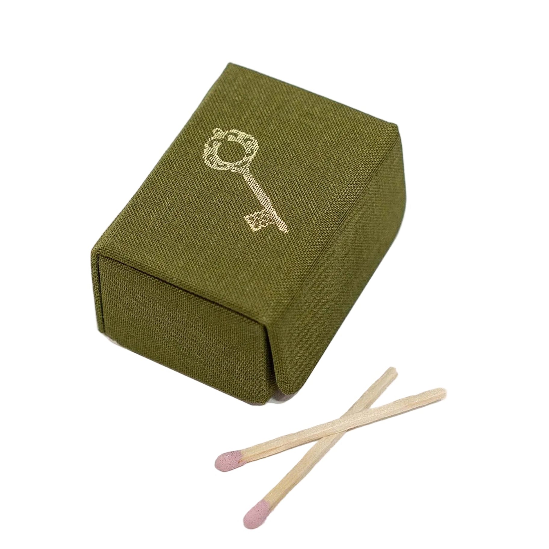 Green matchbox with a key design and two matches on a white background