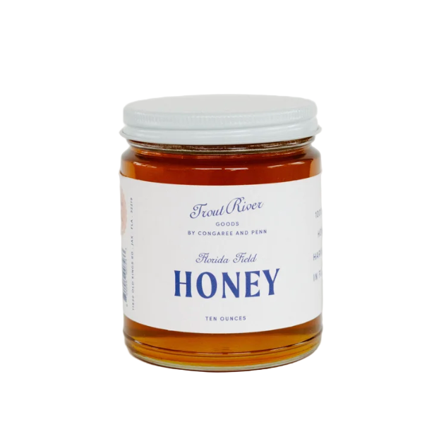 Jar of honey with a label on a white background