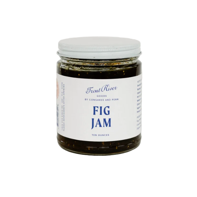 Jar of fig jam with a white label on a light gray background