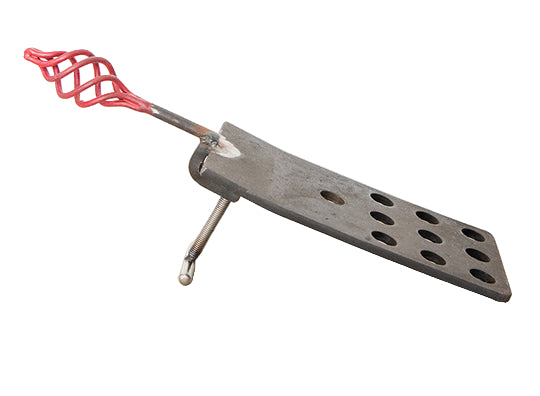 Metal tool with red handle on a wooden surface