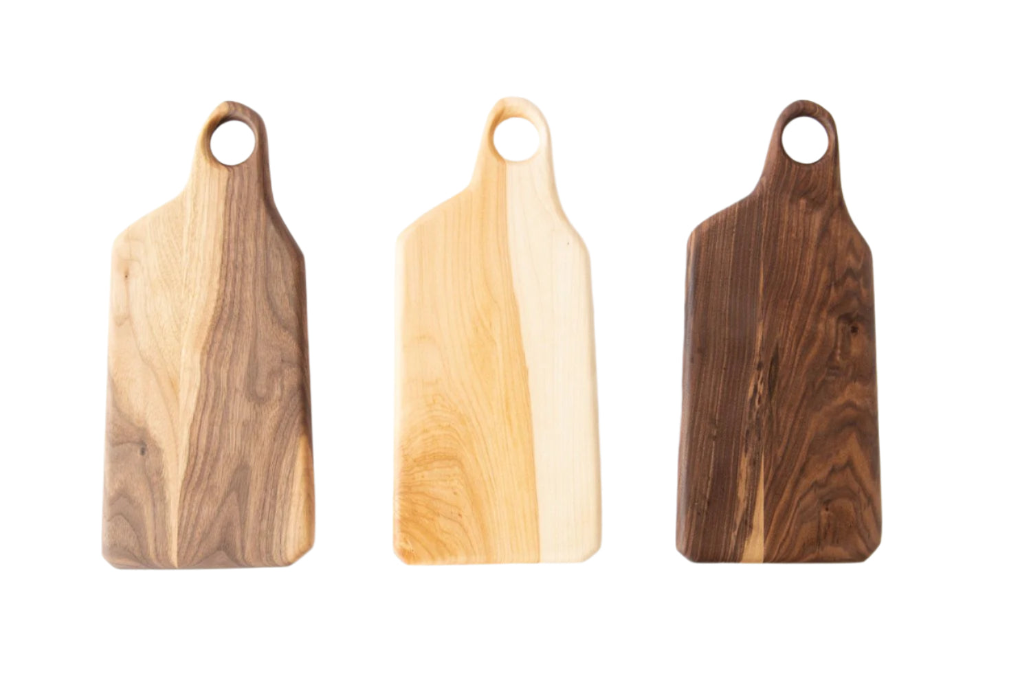 Three wooden cutting boards of different colors on a white background
