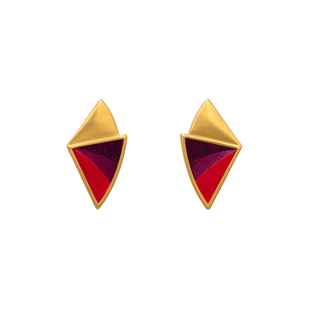 Gold and red geometric earrings on a white background