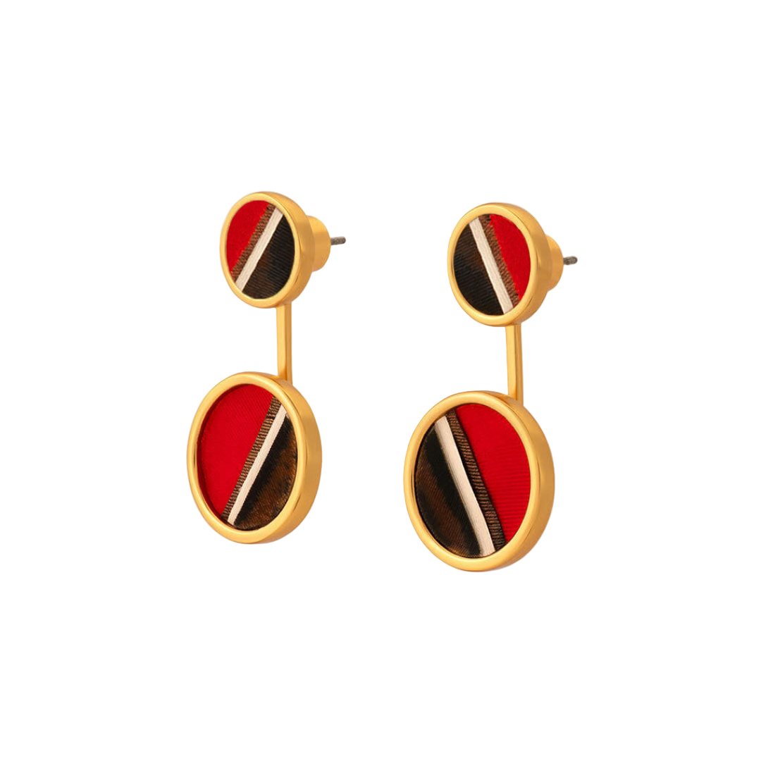 Gold earrings with red and black striped stones on a white background