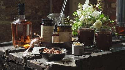 bourbon, gourmet cherries, and pecans on a beautifully set table
